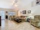 Bright living room features a ceiling fan and many windows at 469 Fairbanks Rd, Spring Hill, FL 34608