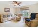 Bright living room featuring large windows with a great view, a ceiling fan and comfortable seating at 469 Fairbanks Rd, Spring Hill, FL 34608