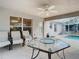 Covered patio with patio furniture, a ceiling fan and a view of the screened-in pool at 469 Fairbanks Rd, Spring Hill, FL 34608