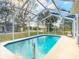 A beautiful in-ground pool with a screened-in enclosure at 469 Fairbanks Rd, Spring Hill, FL 34608