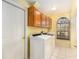 Laundry room featuring tile flooring, a washer, a dryer, upper cabinets and a window at 4739 Mahogany Ct, Land O Lakes, FL 34639