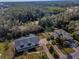 Overhead view of home with mature landscaping and lengthy driveway, providing ample parking for residents and guests at 5050 Limestone Dr, Port Richey, FL 34668