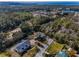An aerial view of a beautiful community surrounded by lush trees and a water view at 5050 Limestone Dr, Port Richey, FL 34668