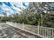 Wooden backyard deck with white railings, perfect for enjoying the serene and private backyard at 5050 Limestone Dr, Port Richey, FL 34668