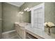 Bathroom featuring double sinks, vanity space, green wallpaper, and tile floor at 5050 Limestone Dr, Port Richey, FL 34668