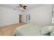 Bright bedroom features neutral carpet, ceiling fan, and convenient access to attached bathroom at 5050 Limestone Dr, Port Richey, FL 34668