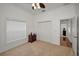 Bright bedroom featuring neutral carpet, a ceiling fan, and closet with paneled doors at 5050 Limestone Dr, Port Richey, FL 34668