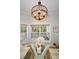 Sunlit breakfast nook with three large windows and modern chandelier at 5050 Limestone Dr, Port Richey, FL 34668