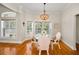 Breakfast nook with large windows, hardwood floors, and a chandelier at 5050 Limestone Dr, Port Richey, FL 34668