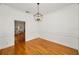 Spacious dining room featuring hardwood floors and access to other rooms at 5050 Limestone Dr, Port Richey, FL 34668
