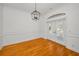 Well-lit dining area with hardwood floors and stylish lighting fixture at 5050 Limestone Dr, Port Richey, FL 34668