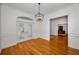 Elegant dining room with hardwood floors, large windows and a modern pendant light at 5050 Limestone Dr, Port Richey, FL 34668