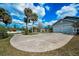 Expansive driveway provides ample parking space, surrounded by mature trees and landscaping at 5050 Limestone Dr, Port Richey, FL 34668
