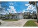Lovely home showcasing a wrap-around porch, attached garage, and well-maintained landscaping at 5050 Limestone Dr, Port Richey, FL 34668