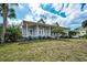 Charming home boasts a covered porch, perfect for relaxing and enjoying the beautiful surroundings at 5050 Limestone Dr, Port Richey, FL 34668