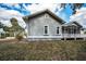 Side view of a well-maintained single-Gathering home featuring a screened porch and manicured lawn at 5050 Limestone Dr, Port Richey, FL 34668
