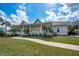 Inviting single-story home with a spacious front porch, enhanced by lush landscaping and a charming walkway at 5050 Limestone Dr, Port Richey, FL 34668
