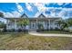 Welcoming single-story home with a classic white porch, complemented by lush landscaping and a stone walkway at 5050 Limestone Dr, Port Richey, FL 34668