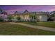 Attractive single-story home with a spacious front porch and beautifully landscaped front yard and walkway at 5050 Limestone Dr, Port Richey, FL 34668