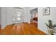 Elegant foyer with gleaming hardwood floors and a view into the home office at 5050 Limestone Dr, Port Richey, FL 34668