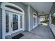 Inviting front porch with a detailed glass front door and covered entrance at 5050 Limestone Dr, Port Richey, FL 34668