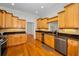 Spacious kitchen featuring wood floors, stainless steel appliances, and ample storage in wooden cabinets at 5050 Limestone Dr, Port Richey, FL 34668