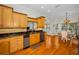 Open-concept kitchen and breakfast nook with stainless steel appliances and natural light at 5050 Limestone Dr, Port Richey, FL 34668