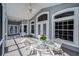 Charming screened patio featuring a glass table and chairs, ideal for outdoor dining and relaxation at 5050 Limestone Dr, Port Richey, FL 34668