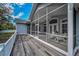 Spacious screened porch featuring ample seating and views of the home's exterior at 5050 Limestone Dr, Port Richey, FL 34668