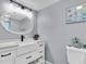 Charming bathroom with a white vanity, stylish mirror, and coastal-themed decorations at 5061 Ensign Loop, New Port Richey, FL 34652