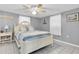Cozy bedroom with calming blue walls, a ceiling fan, and comfortable furnishings at 5061 Ensign Loop, New Port Richey, FL 34652