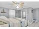 Bedroom with tiled floor, fan, and closet with mirrored sliding doors at 5061 Ensign Loop, New Port Richey, FL 34652