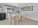 Bright dining area with a view to backyard with a ceiling fan and white wooden chairs at 5061 Ensign Loop, New Port Richey, FL 34652