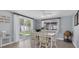 Dining area with sliding doors opens to a lush backyard and ample natural light at 5061 Ensign Loop, New Port Richey, FL 34652
