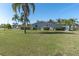 Expansive lawn and mature landscaping surround this lovely single-story home at 5061 Ensign Loop, New Port Richey, FL 34652