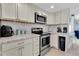 Kitchen boasts updated stainless steel appliances, ample counter space, and stylish cabinetry at 5061 Ensign Loop, New Port Richey, FL 34652