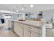 Expansive kitchen island offers seating and serving space with natural light enhancing the countertops at 5061 Ensign Loop, New Port Richey, FL 34652