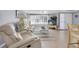 Bright living room featuring plush furniture, a ceiling fan, and large windows with a view, perfect for relaxing at 5061 Ensign Loop, New Port Richey, FL 34652