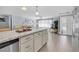 Open floor plan from kitchen to the well lit living room with a large white couch at 5061 Ensign Loop, New Port Richey, FL 34652