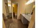 Bathroom featuring a double vanity with a granite countertop, tile floors, and a shower-tub at 5231 Corvette Dr, Tampa, FL 33624