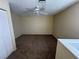 Neutral-toned bedroom featuring neutral carpet, a ceiling fan, and closet space at 5231 Corvette Dr, Tampa, FL 33624