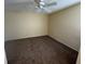 Neutral-toned bedroom featuring neutral carpet and a ceiling fan at 5231 Corvette Dr, Tampa, FL 33624