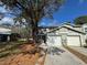 Exterior of home with a front lawn, driveway, and attached garage at 5231 Corvette Dr, Tampa, FL 33624