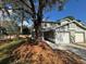 Charming two-story townhome featuring a well-maintained front yard, a red front door, and an attached one-car garage at 5231 Corvette Dr, Tampa, FL 33624