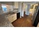 Kitchen featuring granite countertops, stainless steel appliances, and wooden floors, offering both style and functionality at 5231 Corvette Dr, Tampa, FL 33624