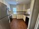 Compact kitchen featuring white cabinets, stainless steel appliances, and granite countertops at 5231 Corvette Dr, Tampa, FL 33624