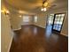 Spacious living room featuring wood floors, ceiling fan, sliding glass doors, and neutral paint, ready for your personal touch at 5231 Corvette Dr, Tampa, FL 33624