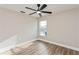 A brightly lit bedroom boasts wood-look flooring and neutral colored walls at 5357 Greystone Dr, Spring Hill, FL 34609