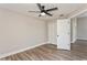 This bedroom features a closet, ceiling fan, and wood-look flooring at 5357 Greystone Dr, Spring Hill, FL 34609