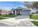 Charming single-story home with well-manicured lawn, driveway, and two-car garage at 5357 Greystone Dr, Spring Hill, FL 34609